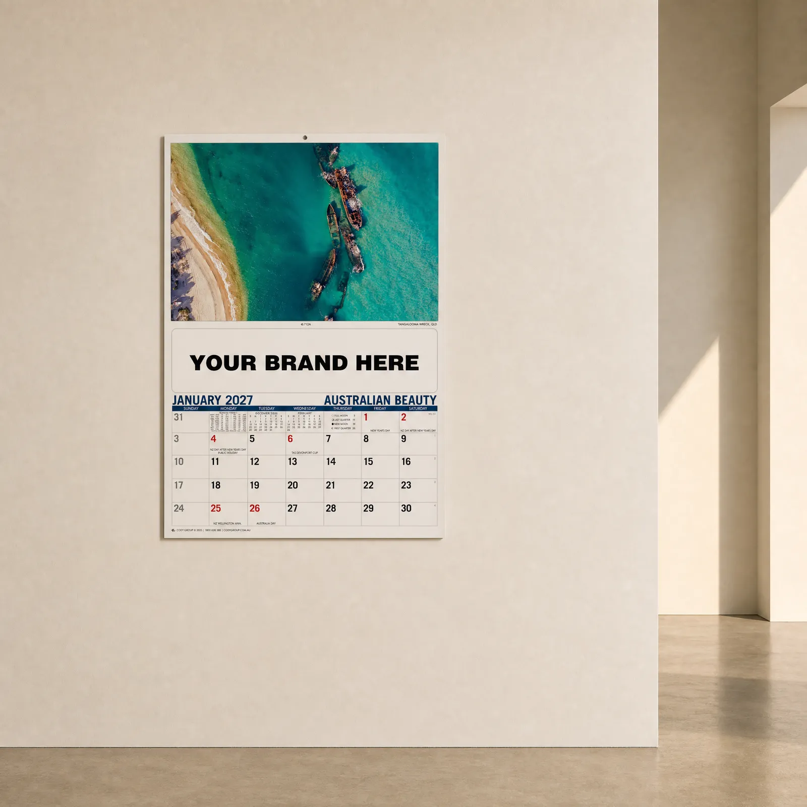 Branded wall calendar mockup hanging on an office wall